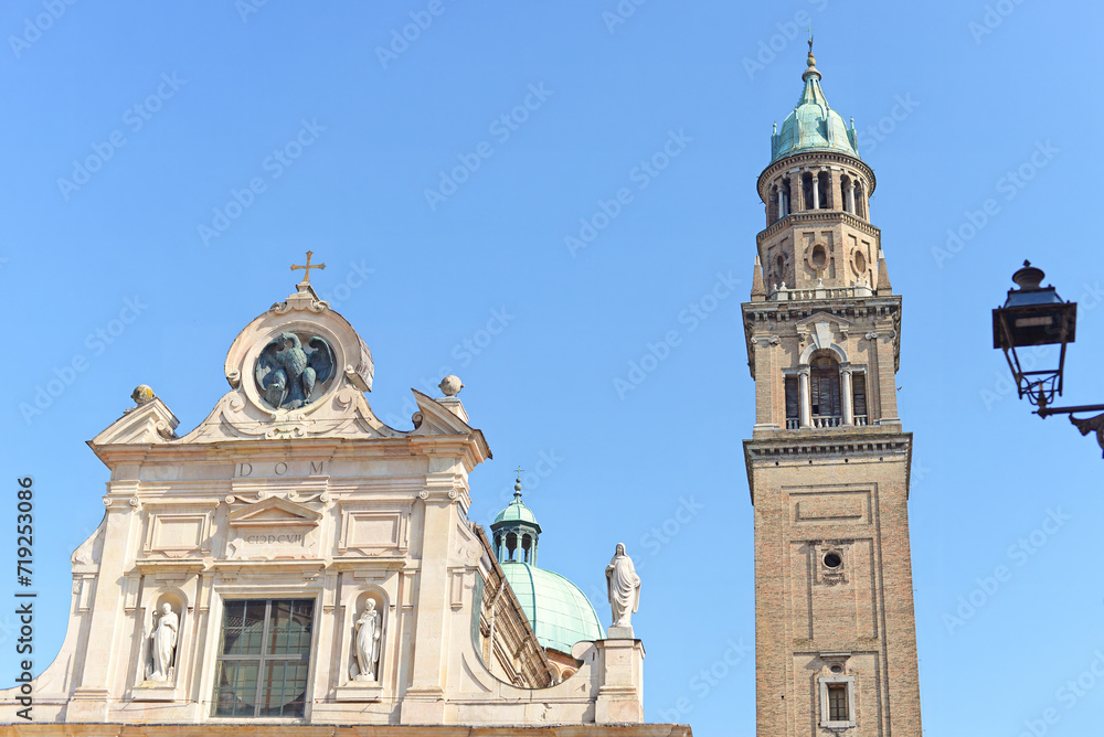 Part of the gable and tower of Parma Cathedral (duomo di Parma) in Roman, Renaissance and Gothic architectural style with blue sky