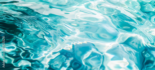 A close-up view of water surface with intricate rippling patterns. The ripples create abstract shapes. The shades of turquoise and white are visible, creating a mesmerizing effect.