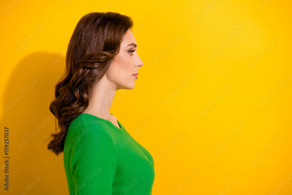Profile side photo of serious adorable girl wear stylish outfit presenting new hairdress empty space isolated on yellow color background Profile side photo of serious adorable girl wear stylish outfit presenting new hairdress empty space isolated on yellow color background