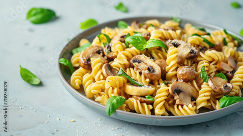 Appetizing pasta with mushrooms, parmesan and basil on a beautiful blue background. Background for design.