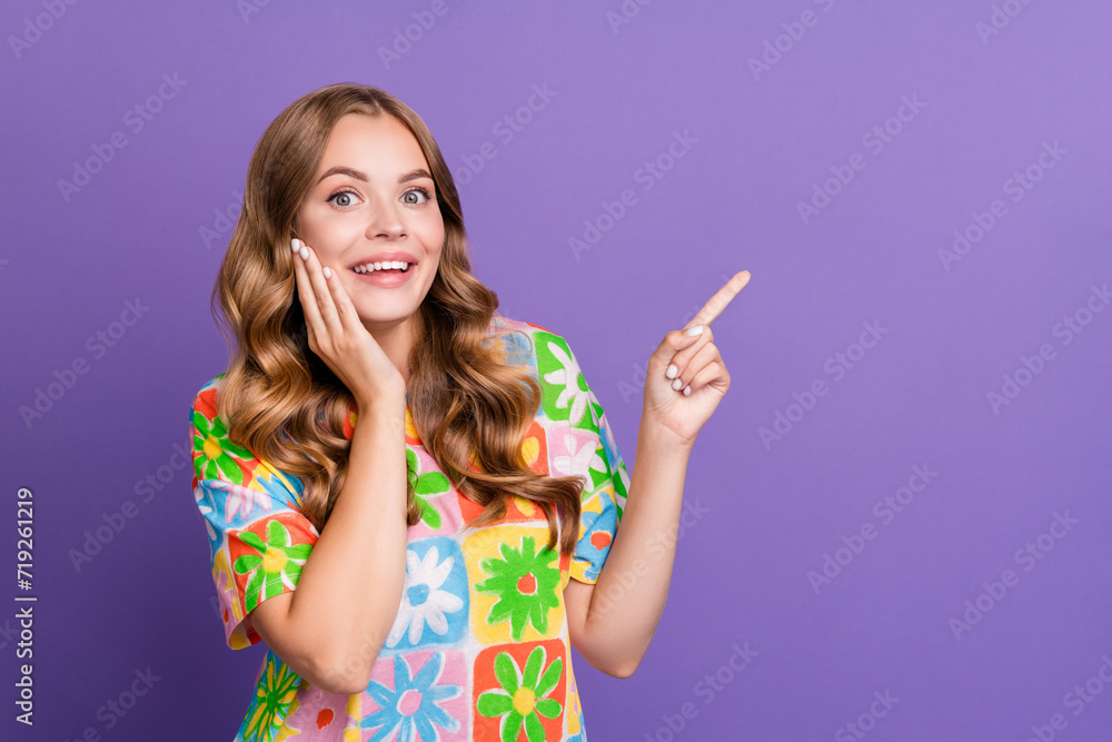 Portrait of excited pretty young lady t shirt direct finger empty space useful website with tips isolated on purple color background Portrait of excited pretty young lady t shirt direct finger empty space useful website with tips isolated on purple color background