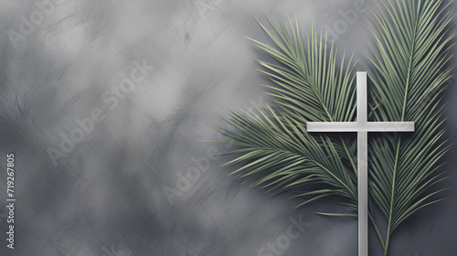 Christian cross and green palm leaf. Gray background. Holy week. Palm Sunday. photo