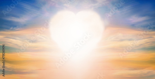 Fluffy clouds forming a heart shape on sunset (sunrise) background, soft focus. Heavenly clouds. Holidays of love, Valentine, Mother day, romantic. Copy space. Empty place.