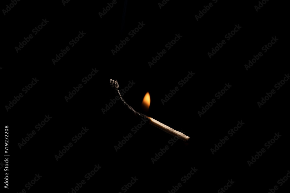 Lit falling match on a black background. Lit falling match on a black background.