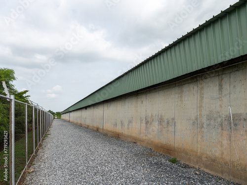 The barbed wire fence surrounds the water storage building.