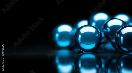 Blue acrylic balls placed on a black background with space for text. © Shabnam