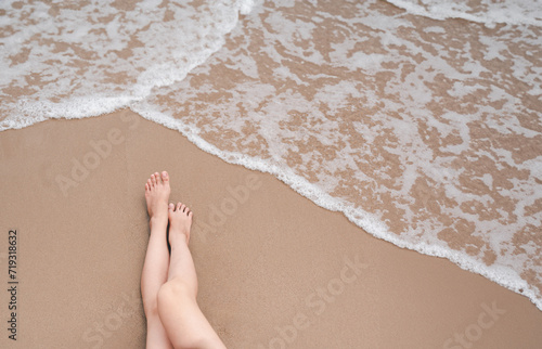beach, sand, relax, sea, summer, vacation, girl, holiday, tropical, female. barefoot standing at near the white clear water sandy beach and looking at my feet at beach with wave from above shot. photo