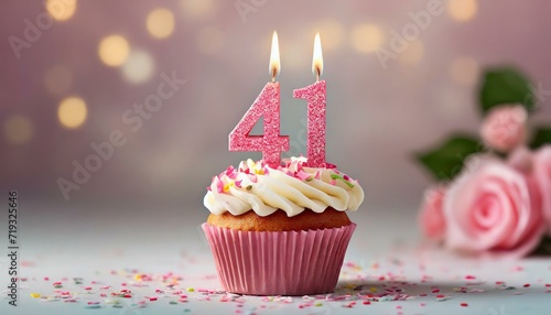 Birthday cupcake with burning lit candle with number 41. Number fortyone for fortyone years or fortyfirst anniversary. photo