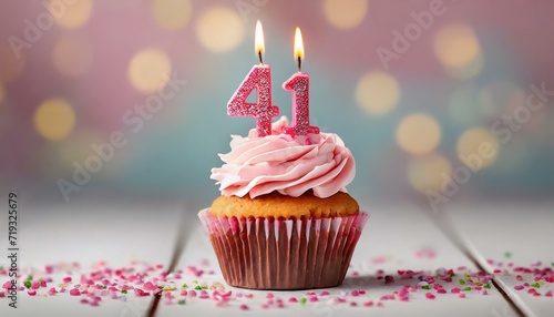 Birthday cupcake with burning lit candle with number 41. Number fortyone for fortyone years or fortyfirst anniversary.