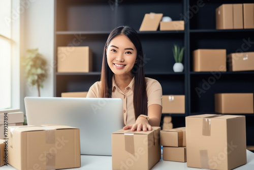 Asian happy woman at the office preparing boxes and delivering sales. Concept of Selling products online.