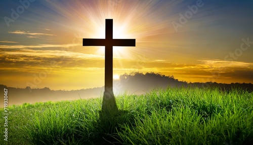 silhouette christian cross on grass in sunrise © Leila