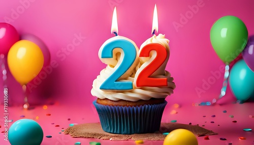 Birthday cupcake with burning lit candle with number 22. Number twentytwo for twentytwo years or twentysecond anniversary. photo