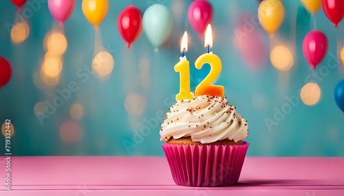 Birthday cupcake with burning lit candle with number 12. Number twelve for twelve years or twelfth anniversary.