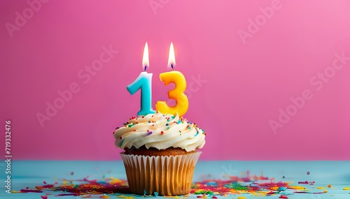 Birthday cupcake with burning lit candle with number 13. Number Thirteen for Thirteen years or thirteenth anniversary. photo