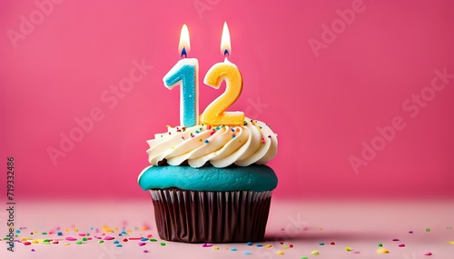 Birthday cupcake with burning lit candle with number 12. Number twelve for twelve years or twelfth anniversary. photo