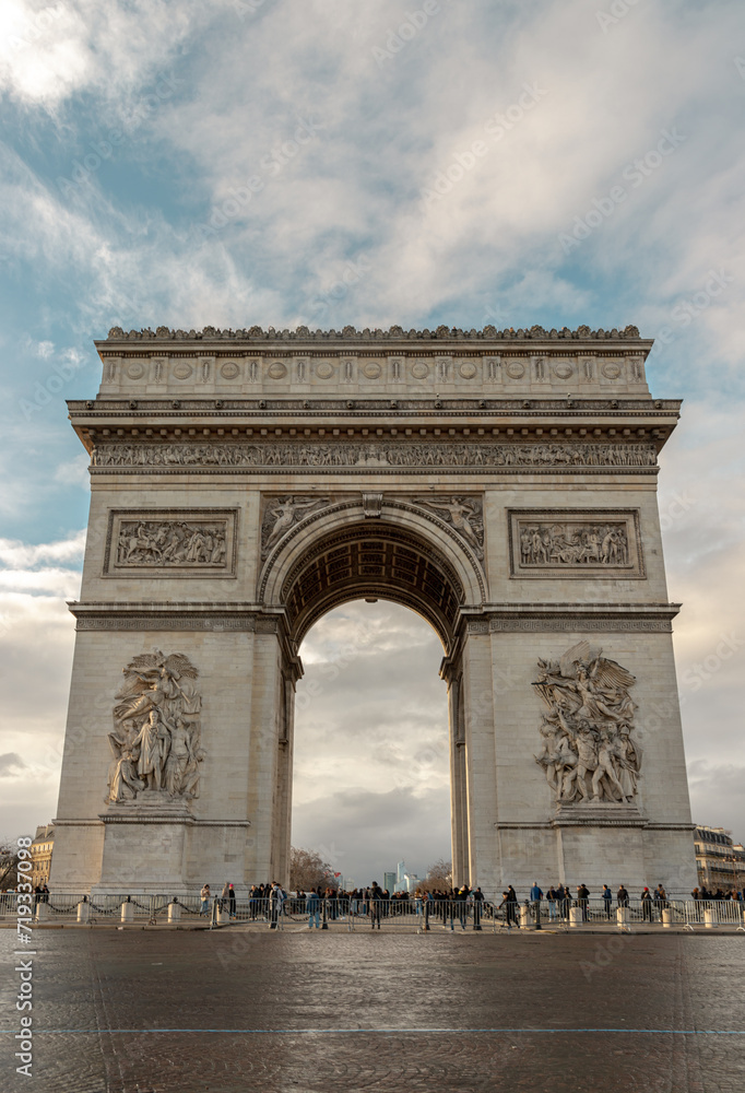 Famous Arc de Triomphe (Triumphal Arch) at the city center of Paris and traffic trails in Chaps Elysees. Symbol of the glory and historical heritage, Iconic touristic architectural landmark, Tourism.
