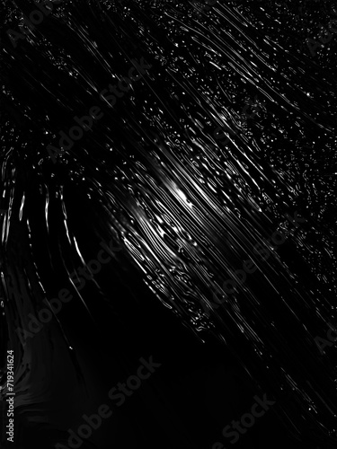 Wrinkled plastic wrap texture on a black background