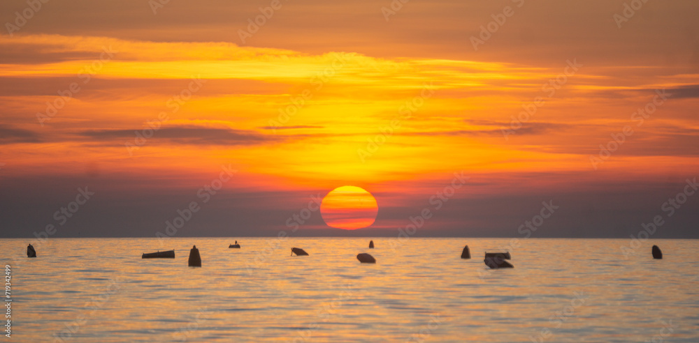 Close look into the sun during sunset in the sea Close look into the sun during sunset in the sea
