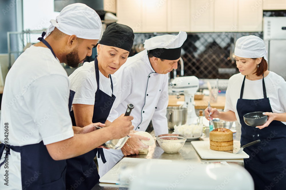 multicultural chefs in blue aprons and toques working hard on their pastry together, confectionery multicultural chefs in blue aprons and toques working hard on their pastry together, confectionery