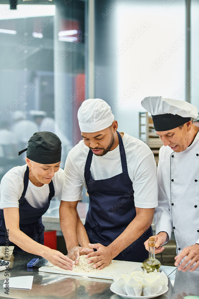 handsome african american chef working with dough while his friend and chief cook helping him