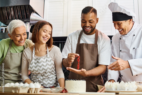 good looking african american man with braces decorating cake with berries near chef and his friends