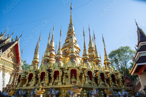 group of small golden pagoda in Wat Phra That Suthon Mongkhon Khiri, Phrae province, northern of Thailand. photo