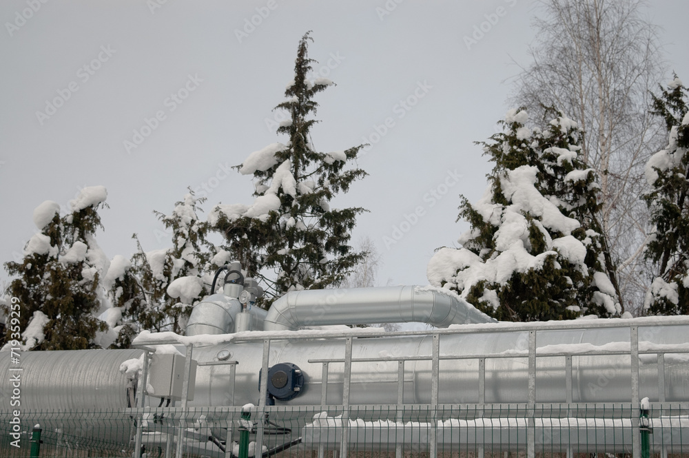 pipelines in winter against the backdrop of a snow-covered forest pipelines in winter against the backdrop of a snow-covered forest