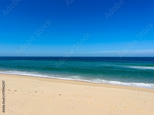 Blue seascape  sandy sea coastline  empty wild beach  pure blue sky  sea horizon