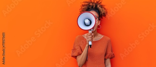 Person With Megaphone Promotes Marketing And Sales Against Vibrant Orange Backdrop. Сoncept Megaphone Marketing, Sales Promotion, Vibrant Orange Backdrop photo