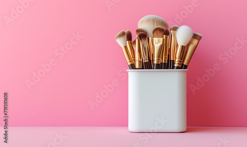  a white vanity case with makeup brushes on a pink bac photo