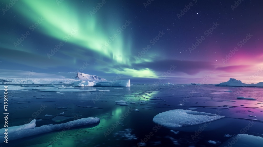 The aurora lights shine brightly in the night sky over an ice floese and icebergs in the ocean, northern lights