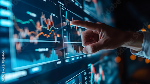 Close-up photo of person touches a digital screen with stock market charts. Successful trading concept