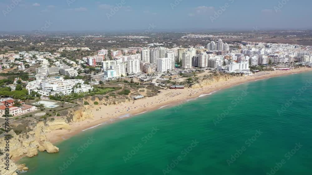 Armacao de Pera City. Popular tourist destination with fine beaches, hotels, cafés and restaurants, situated in South of Portugal. Drone forward slowly descending. Armacao de Pera City. Popular tourist destination with fine beaches, hotels, cafés and restaurants, situated in South of Portugal. Drone forward slowly descending.
