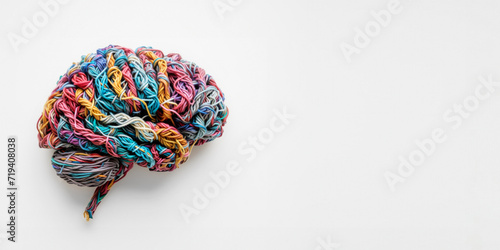 Human brain made of multi-colored tangled threads on white background, banner with copy space, concept of neurodiversity and mental problems