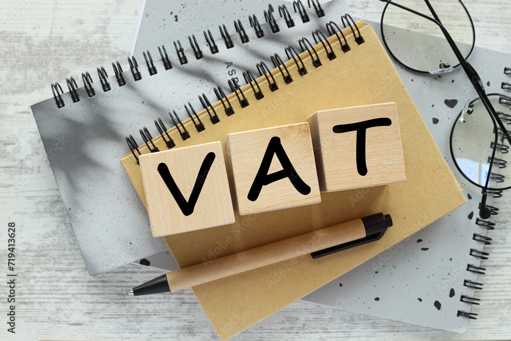 VAT concept in 2024. Wooden letter VAT and number 2024 on a wooden