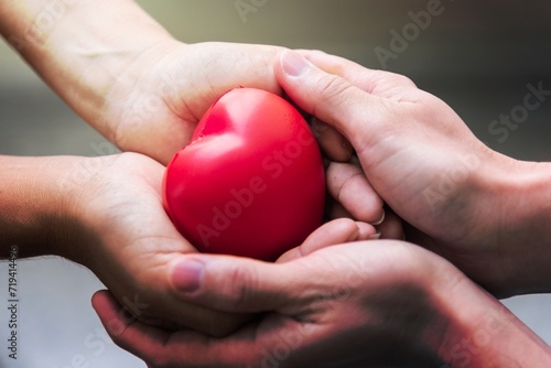Close up hand giving red heart as heart donor. Valentine day of love concept. Medical ventilator and heart donator charity. Sign of compassion and healthy. Helping doctor hand in freedom life donation photo