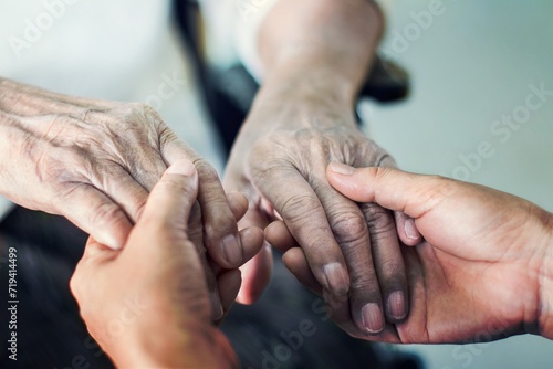 Close up hands of helping hands elderly home care. Mother and daughter. Mental health and elderly care concept photo
