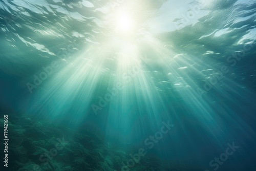 The sun casts brilliant rays through the pristine ocean water, illuminating the underwater world with its radiant glow.
