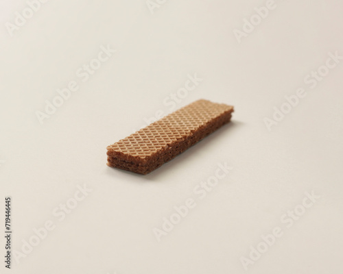 Wafers with chocolate flavored cream on a white and wooden background. Wafer With Chocolate Drizzle. A set of delicious crispy sweet wafers of different shapes. long, square, tasty and crunchy cake.