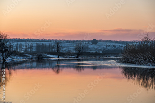A spectacular winter sunset landscape in the Russian countryside with waterfront. Surroundings of Taganrog. photo