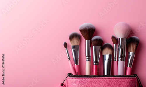  makeup brushes and cosmetic case on pink background i