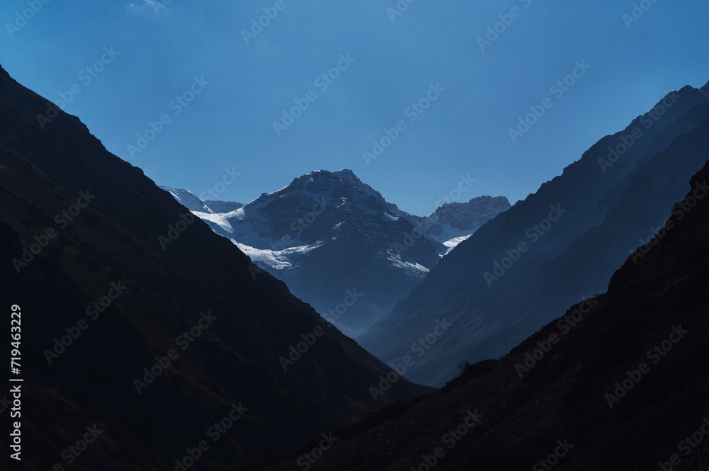 mountain peaks of glaciers with snow on the background of a blue