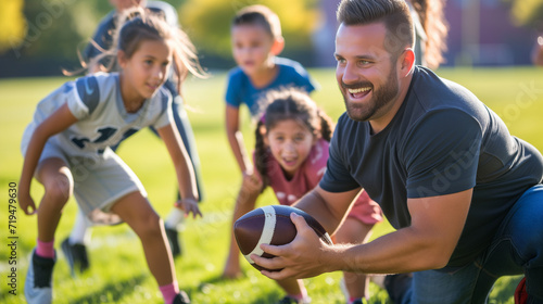 Elementary school coach playing American football with his students