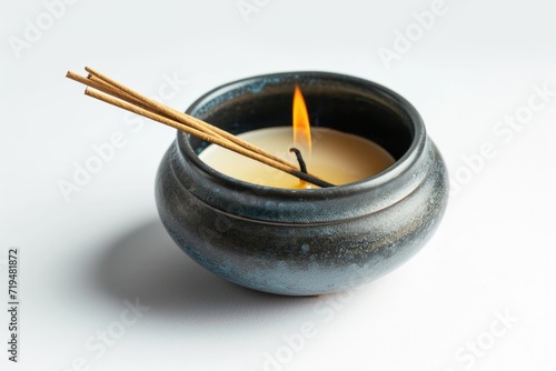 A lit candle placed inside a ceramic pot. This image can be used to create a cozy and warm atmosphere in various settings