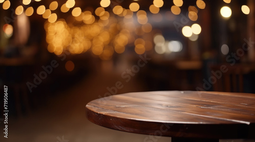 Wooden table in restaurant with beautiful lights in background. Perfect for showcasing cozy dining experience. © vefimov