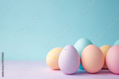 Isolated Pastel-colored Easter eggs sit on a soft blue background. The simplicity and pastel palette evoke a calm  festive mood  suitable for springtime holiday themes.