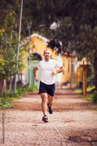 Mature man running, workout and streetching at the city park © Helder Almeida