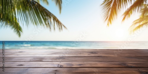 Empty wood table with seascape and palm leaves, blur bokeh light of calm sea and sky at tropical beach. Ready for product display montage. Summer vacation concept.