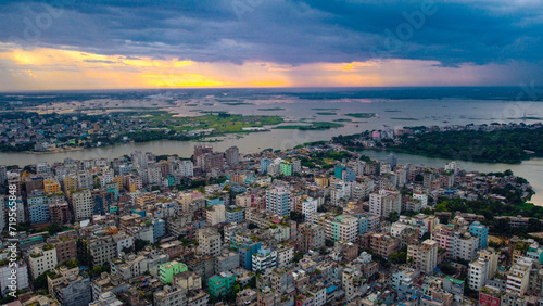 Aerial urban Sunset in a dense city by the water . Dhaka is the capital of Bangladesh and one of the most populated city in the World.