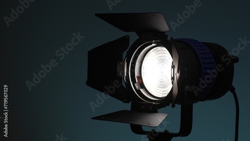 Studio light with fresnel lens and barndoors. Selective focus, close-up.